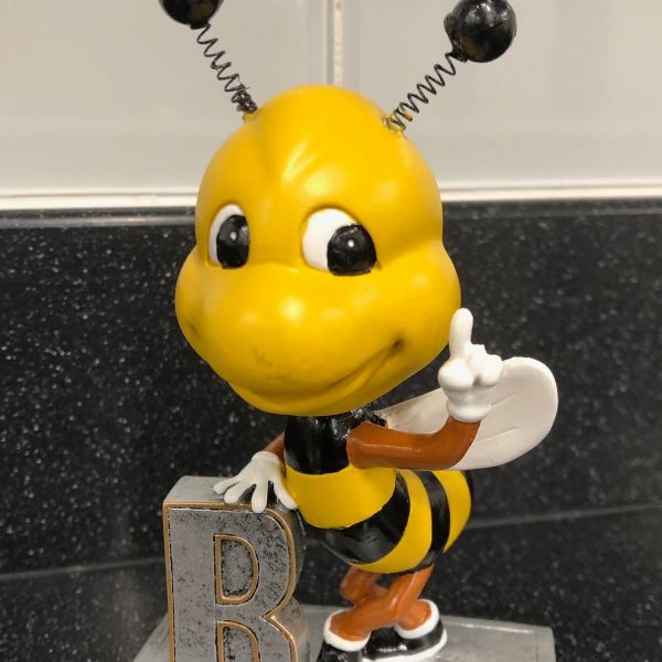  statue of a bee on a trophy